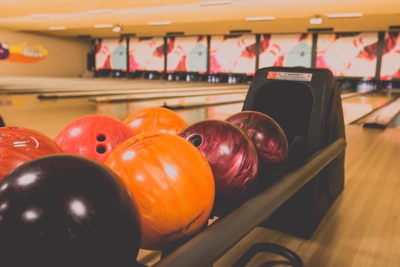 Bowling balls on a rack in the bowling alley