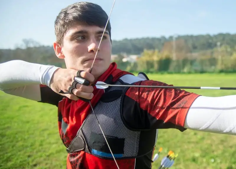 Archer with shoulder pad and strung bow