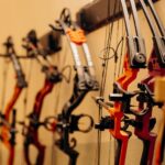 compound bows hanging on wall