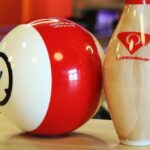 White and red bowling ball and pin