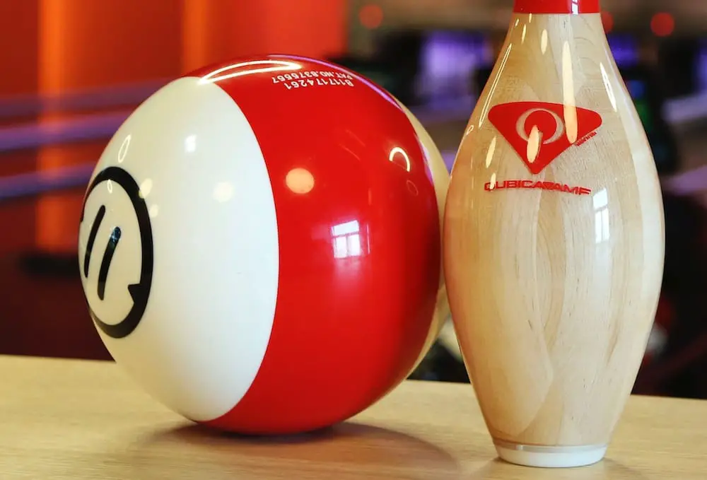 White and red bowling ball and pin